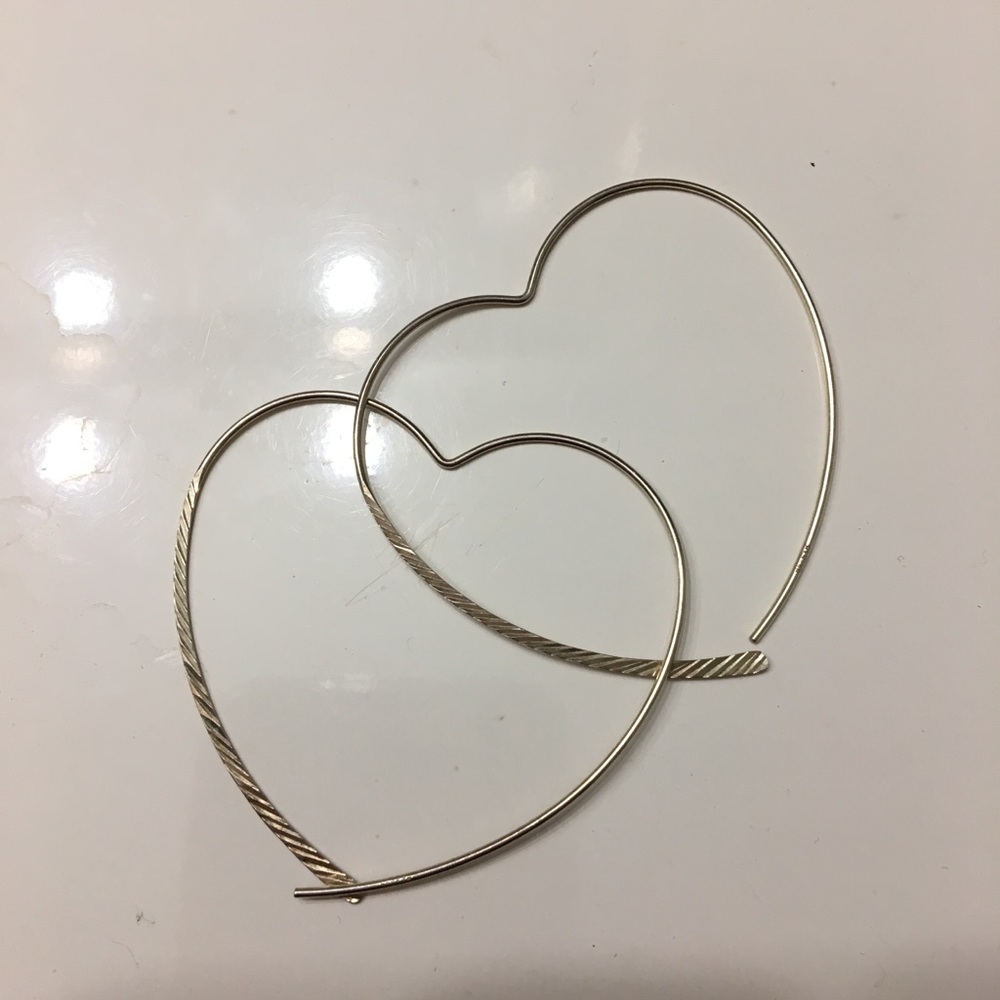 Sterling silver heart shaped hoops.